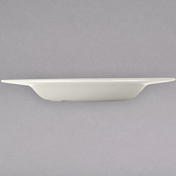 A white Carlisle melamine bowl on a white plate.