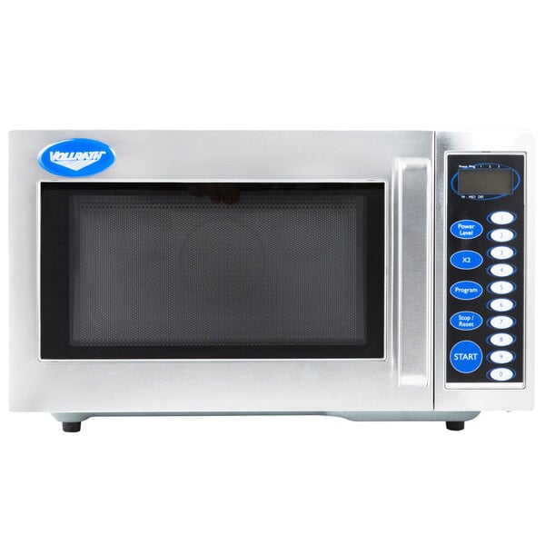 A close-up of a silver Vollrath commercial microwave with blue buttons.