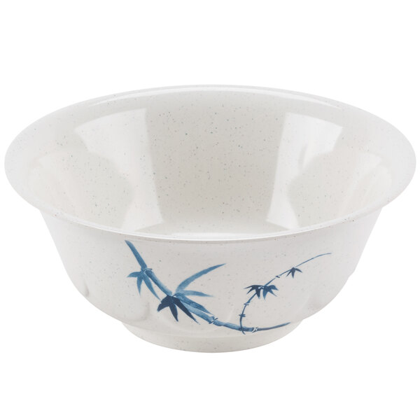 A white bowl with blue bamboo design on it.