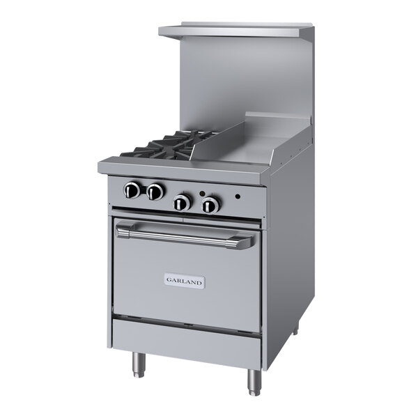 A close-up of a large stainless steel Garland range with two burners, a griddle, and an oven.