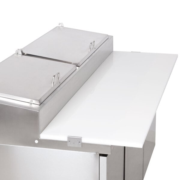 A white cutting board on a stainless steel counter.