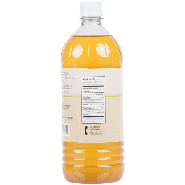 A close-up of a bottle of orange liquid.