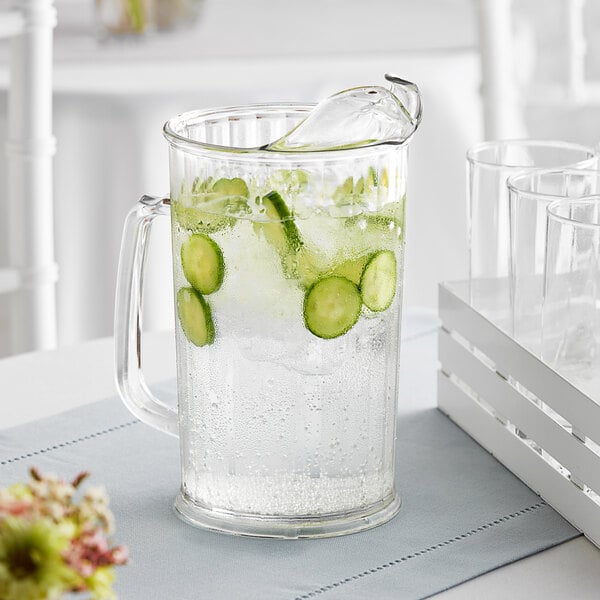 A Cambro clear plastic pitcher filled with water, cucumbers, and ice.