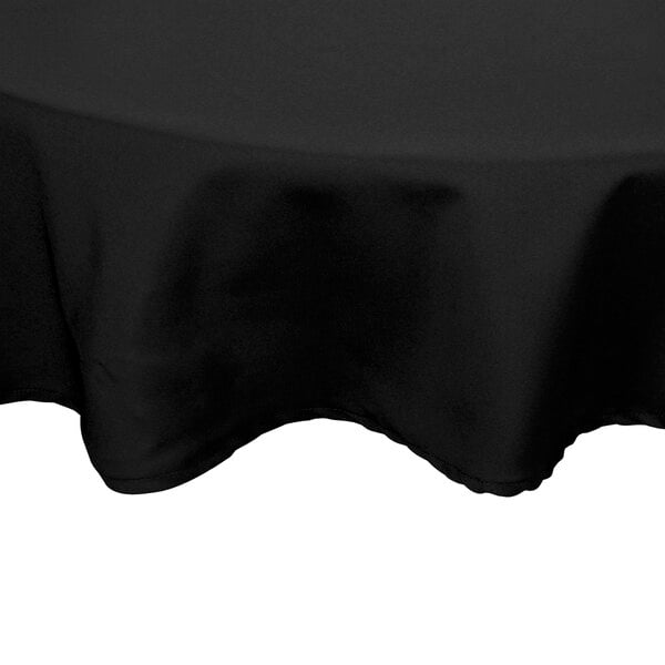 A black Intedge round tablecloth with a hemmed border.