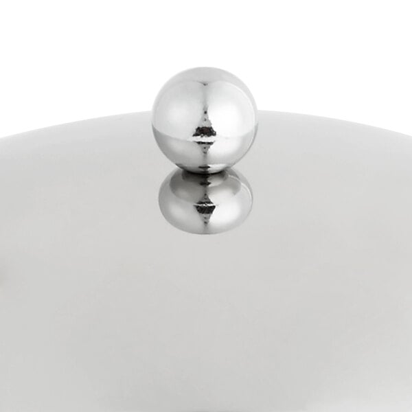 A stainless steel wok cover with a silver ball handle.