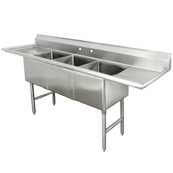 An Advance Tabco stainless steel three compartment commercial sink with two drainboards on a counter.