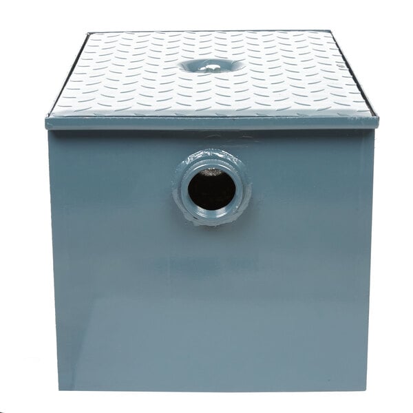 A blue metal Watts grease trap with a hole in the top.