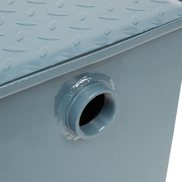 A metal Watts grease trap with threaded connections.