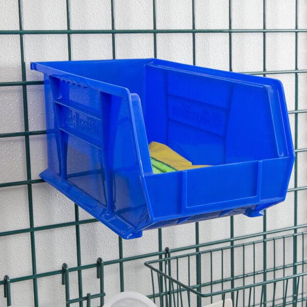 A blue plastic Metro bin holder with a yellow bin inside.