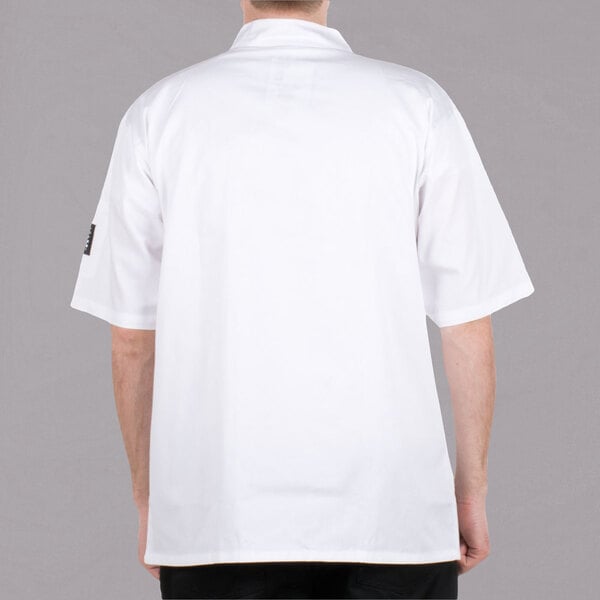 A man wearing a white Chef Revival short sleeve chef coat.