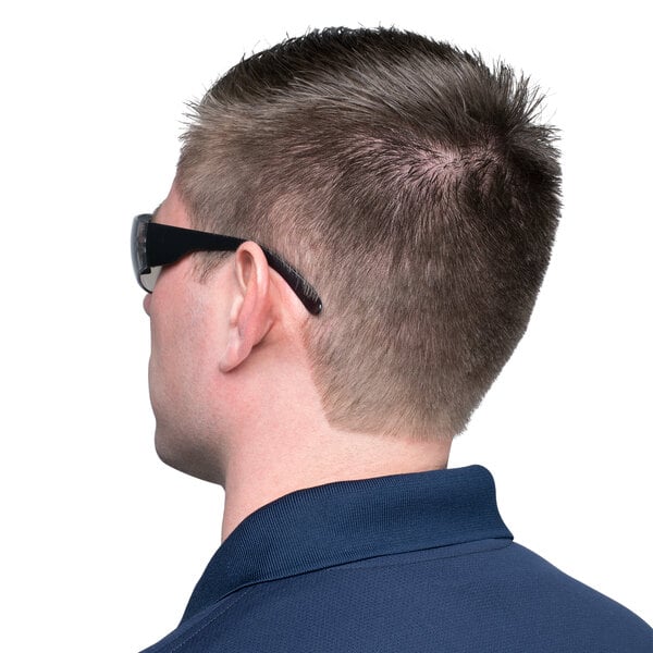 A man wearing Cordova scratch resistant safety glasses with indoor/outdoor lenses.