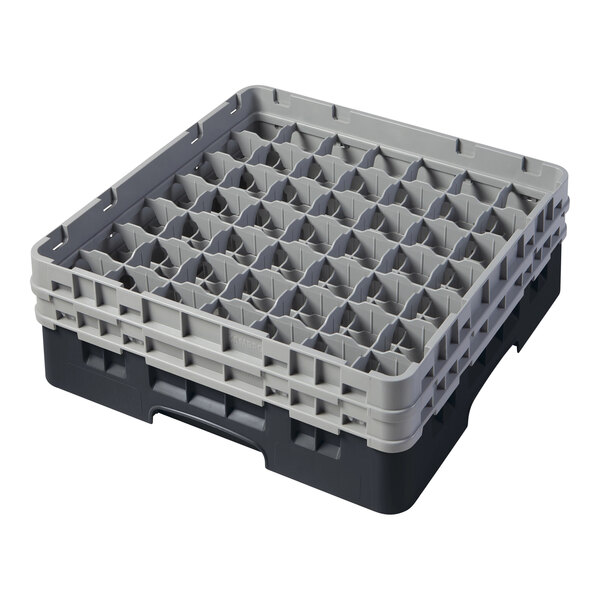 A black Cambro plastic glass rack with many compartments and extenders.