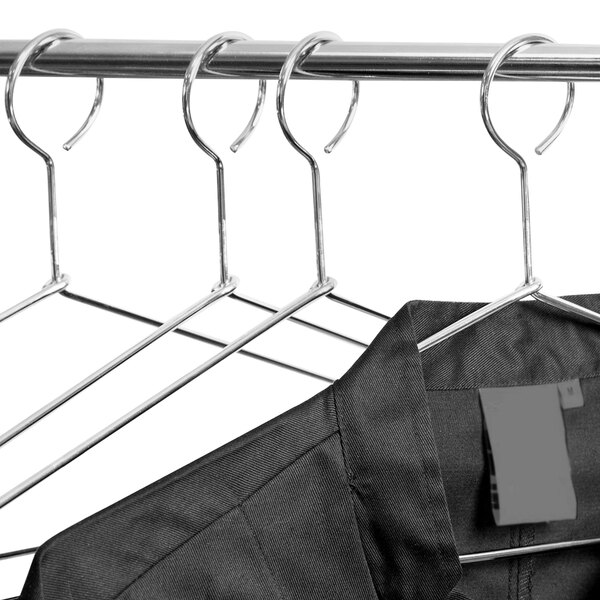 A black shirt hangs on a closed hook metal hanger.