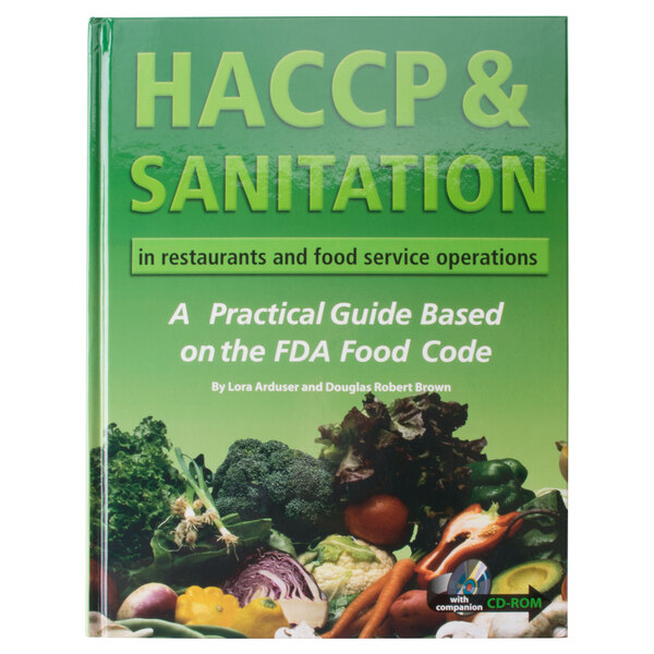 A green book with white text that reads "HACCP & Sanitation in Restaurants and Food Service Operations" on a restaurant counter.