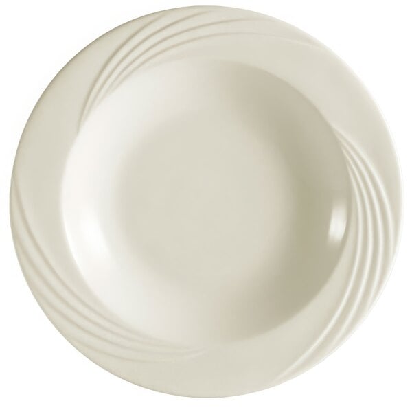 A white porcelain soup plate with a wavy design on the rim.