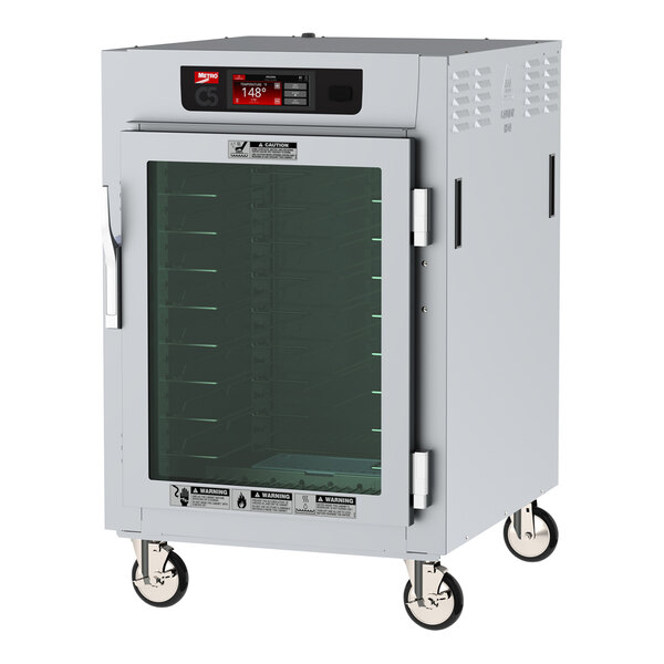 A white Metro C5 holding cabinet with a clear glass door on wheels.