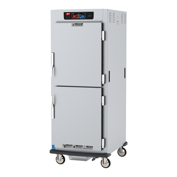 A white metal cabinet on wheels with two doors.