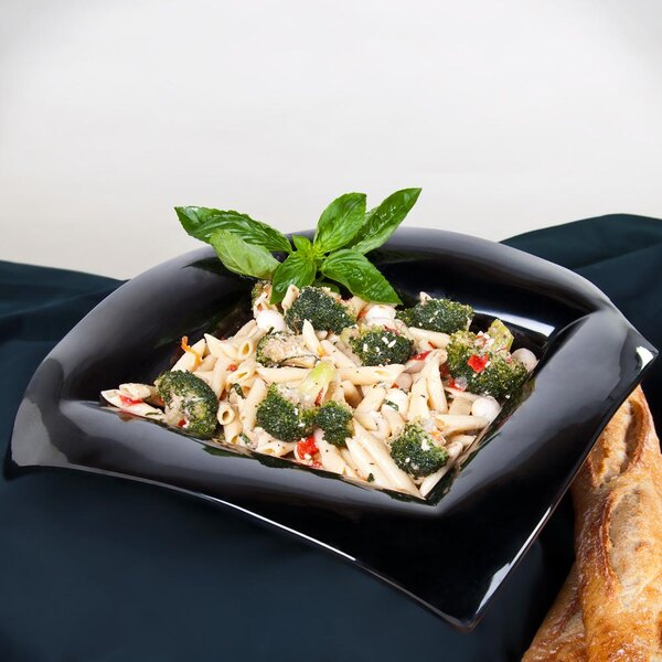 A black GET Geneva bowl filled with pasta and broccoli on a table.