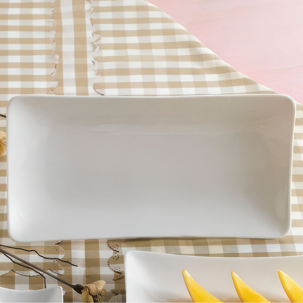 A CAC rectangular white porcelain platter with fruit on it.