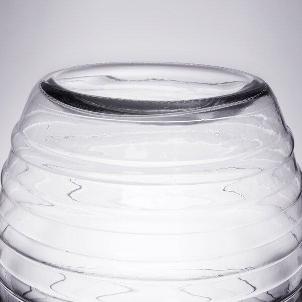 A clear glass barrel with a round lid.