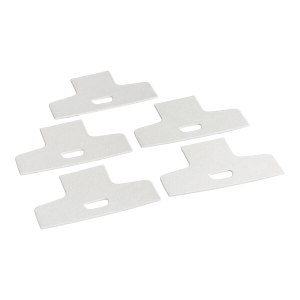 Five white, flat, T-shaped pads with a rectangular cutout in the center, arranged on a white background.