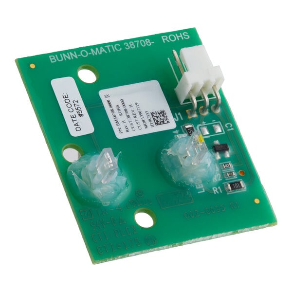 A close-up of a green circuit board with white and black text.