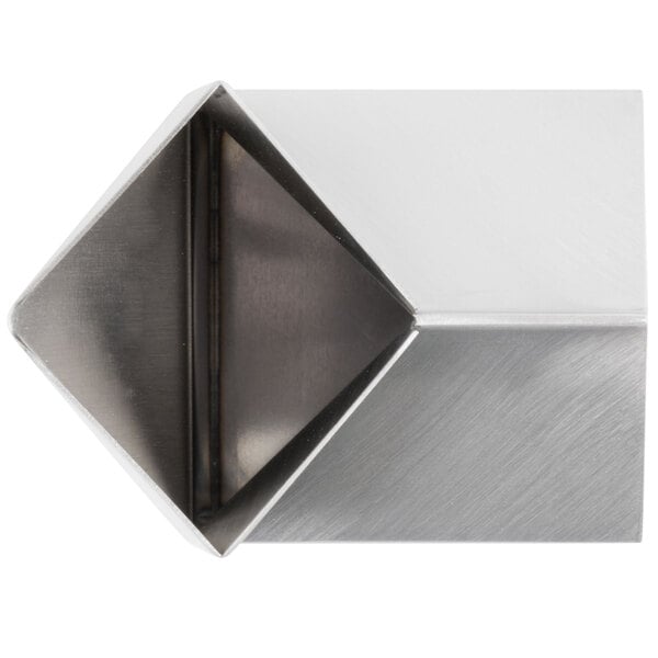 An American Metalcraft stainless steel milk carton creamer with a triangular shape.