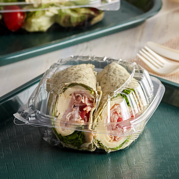 A Dart ClearSeal plastic container with a sandwich inside.