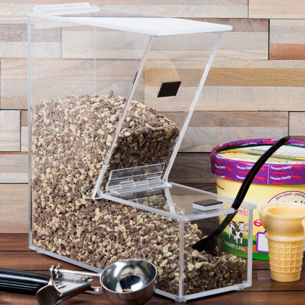 A Cal-Mil classic topping dispenser on a counter with a clear plastic container and a black lid.