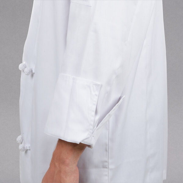 A close up of a white Chef Revival chef coat with knot cloth buttons.