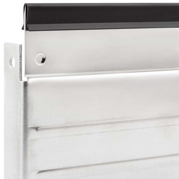 A silver metal Bron Coucke central blade for a mandoline.