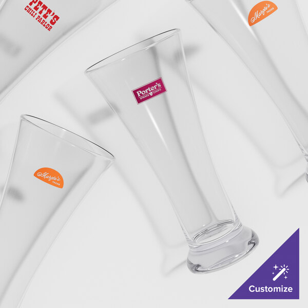 A group of customizable flared plastic pilsner glasses.