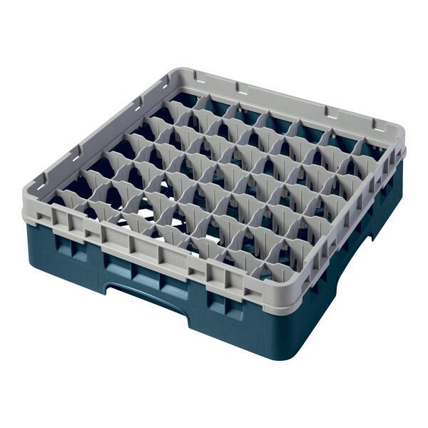 A teal plastic Cambro glass rack with many small compartments.