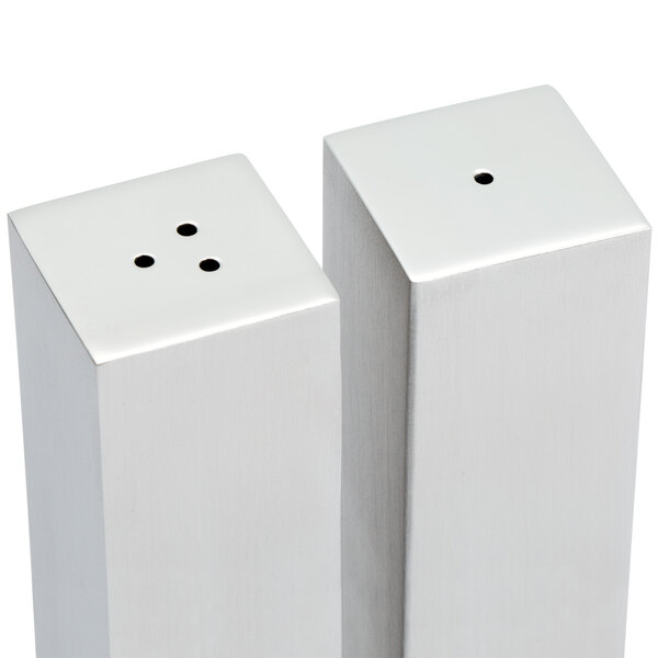 An American Metalcraft stainless steel salt and pepper shaker set with rectangular shakers on a table.