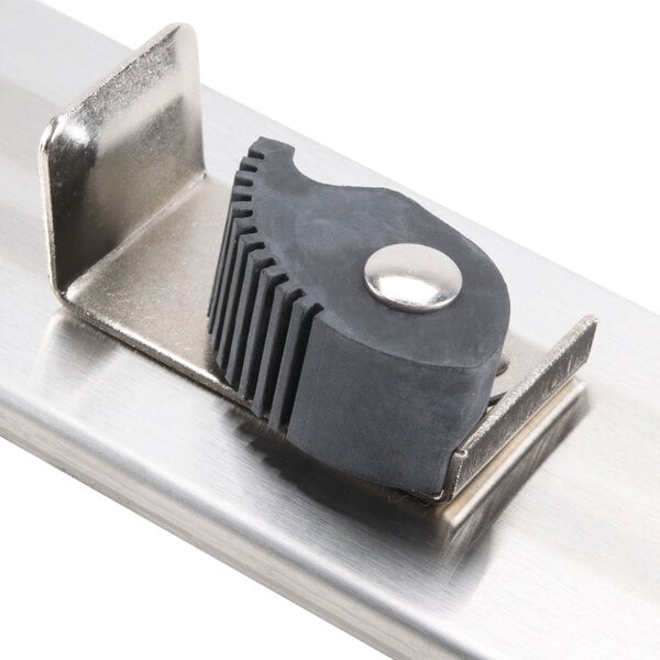 A stainless steel mop hanger with a black rubber grip on the metal surface.