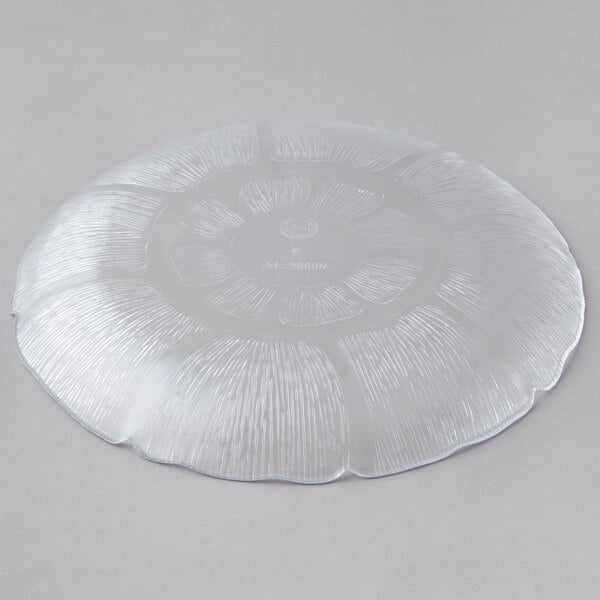 A Carlisle clear plastic plate with a flower design.