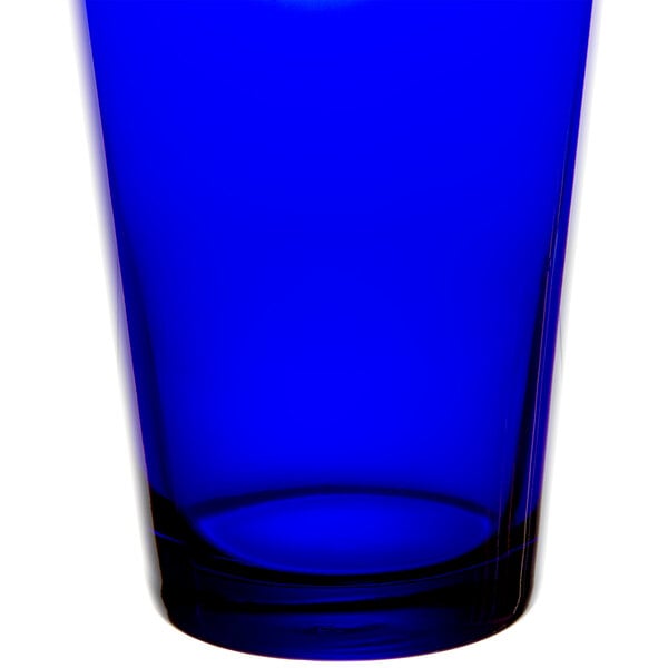 A blue glass tumbler with a clear rim.