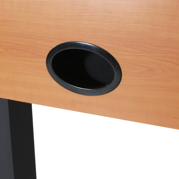 a black oval object on a wood surface