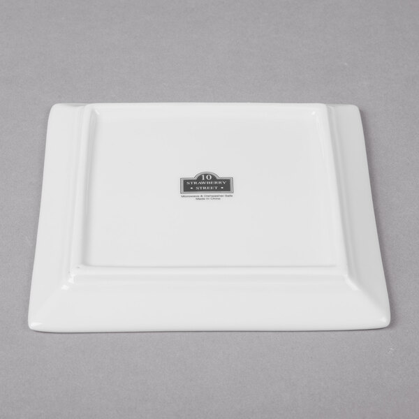 A white square porcelain bread and butter plate with a logo on it.