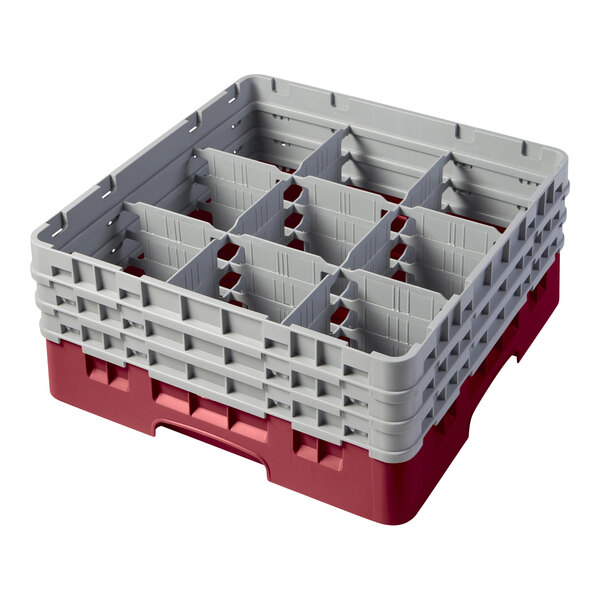 A red plastic Cambro glass rack with 9 compartments and 3 gray extenders.