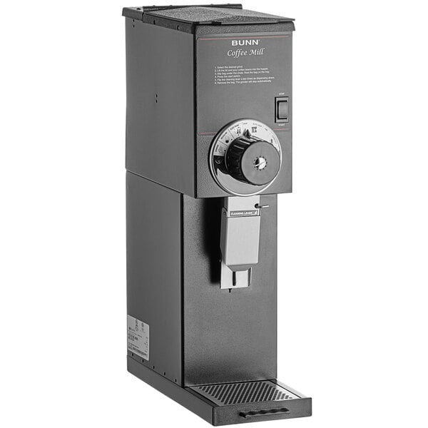 A black rectangular Bunn coffee grinder with a dial.