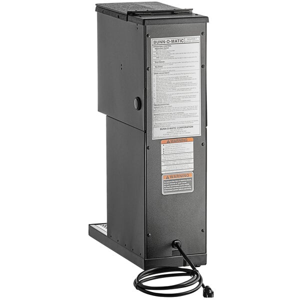 A black rectangular Bunn coffee grinder with a black wire.