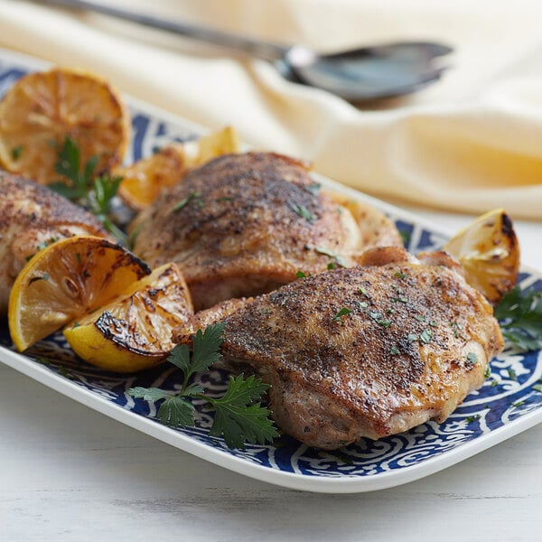 A plate of food with Regal Mediterranean Herb Blend, lemons, and herbs.