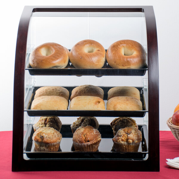 A Cal-Mil Westport wood display case filled with pastries.