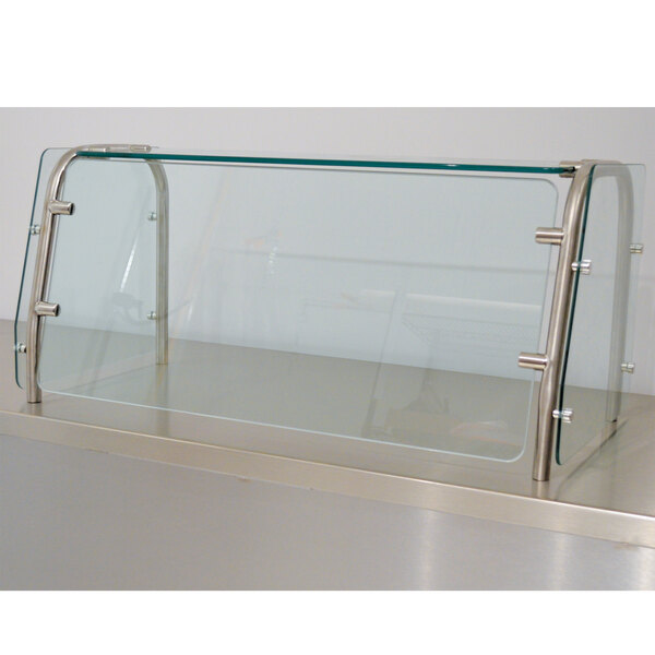 An Advance Tabco cafeteria food shield with a metal frame and glass shelves.