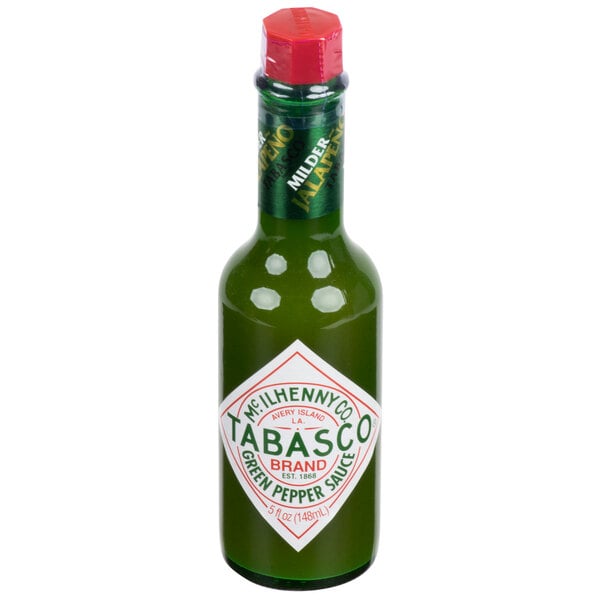 A close-up of a TABASCO Green Pepper Hot Sauce bottle with a green label and red cap.