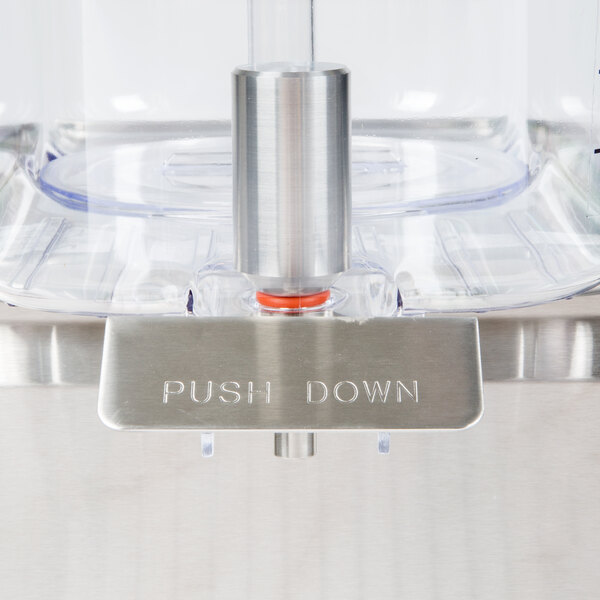 The stainless steel bowl of a Crathco refrigerated beverage dispenser.