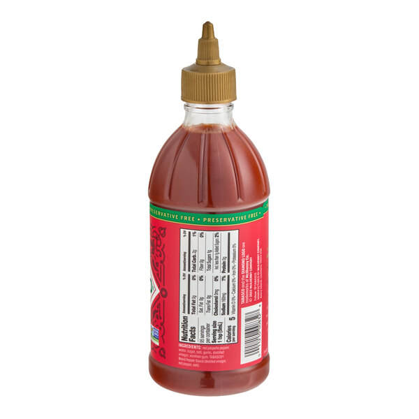 A plastic squeeze bottle of TABASCO Sriracha Hot Sauce with a red label and gold cap.