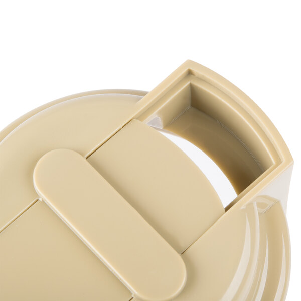 A beige plastic Tablecraft dressing top with a handle.