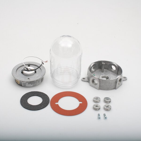 A clear plastic jar with a round metal object and a round metal object with a hole in it.